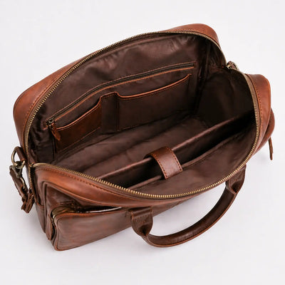 Brown leather bag with open interior on a white background