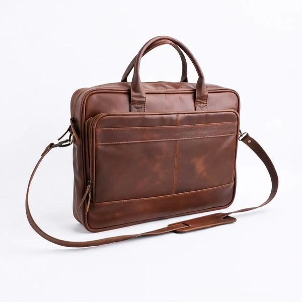 Brown leather bag with shoulder strap on a white background