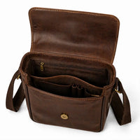 Brown leather bag with open compartments on a white background
