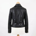 Black leather jacket on a mannequin against a white background