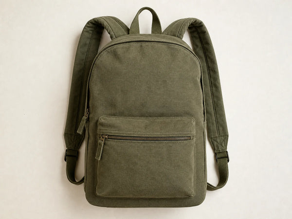 Photorealistic product mockup of a blank olive heavyweight canvas day backpack with a front zip pocket viewed overhead.