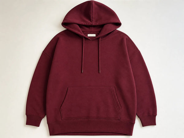 Custom drop-shoulder longline hoodie in deep maroon heavyweight fleece, front flat lay