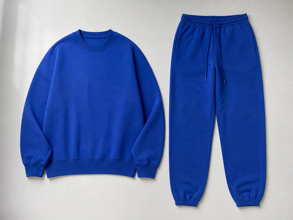 Custom cobalt drop-shoulder tracksuit with oversized sweatshirt and joggers, front flat lay