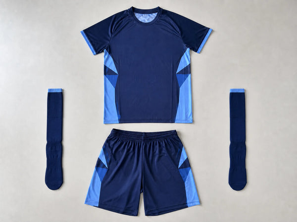 Custom navy and sky blue football kit with jersey, shorts and socks, front flat lay