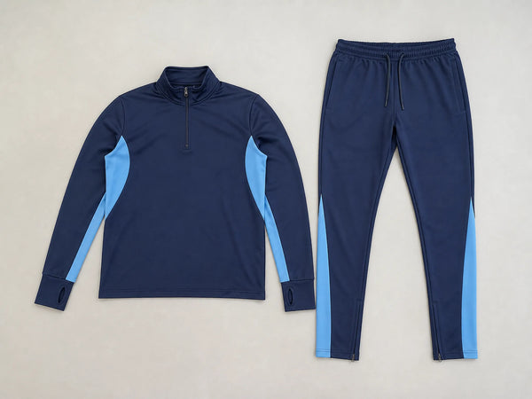 Custom navy football training suit with sky blue panels, front flat lay