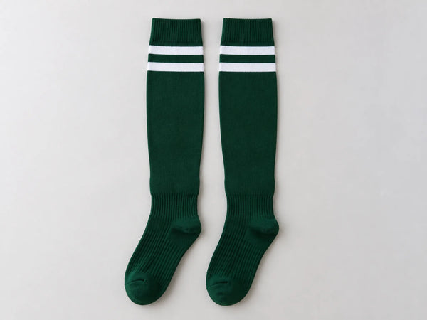 Custom pair of forest green and white hockey socks, front flat lay
