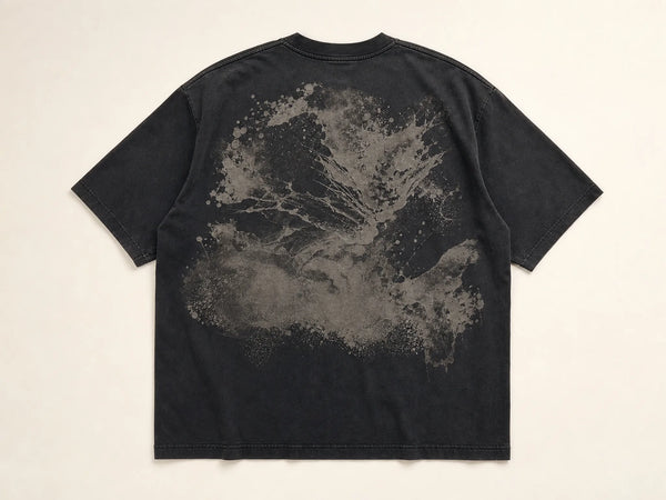 Photorealistic product mockup of the back of a washed-black oversized cotton T-shirt with a large abstract stone-grey print.