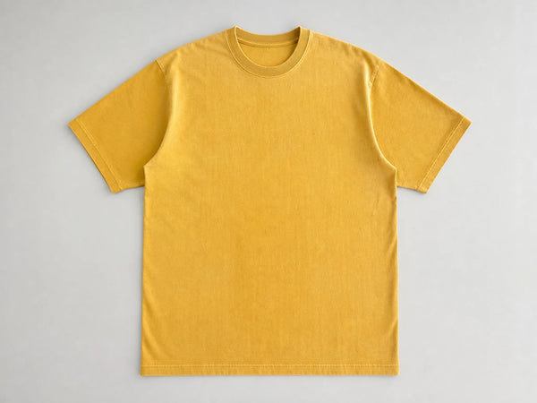 Custom pigment-dyed T-shirt in faded mustard cotton, front flat lay