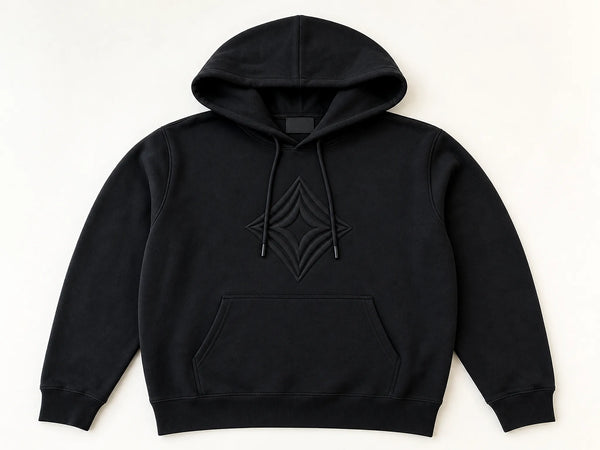 Custom black streetwear hoodie with tonal geometric puff print, front flat lay