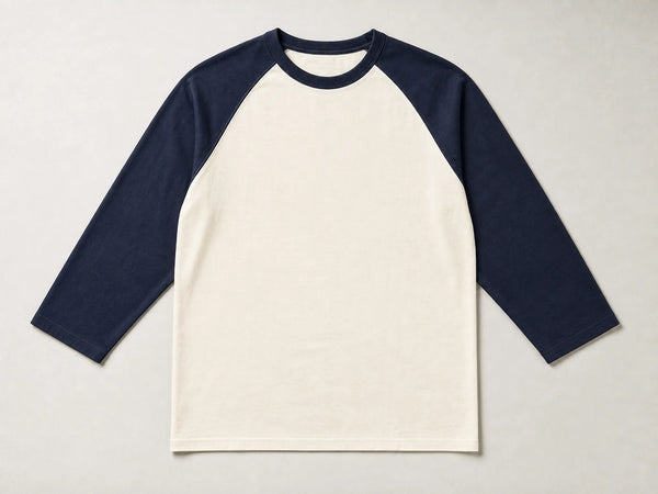 Custom raglan baseball T-shirt with cream body and navy sleeves, front flat lay