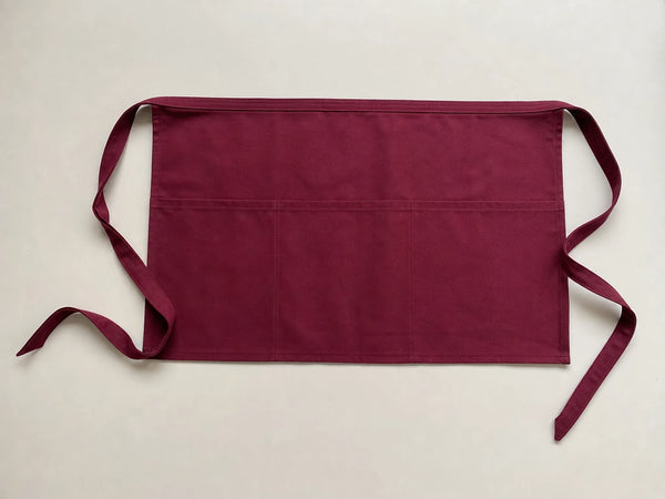 Custom burgundy waist apron, front flat lay