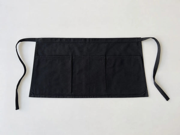 Custom black waiter waist apron, front flat lay