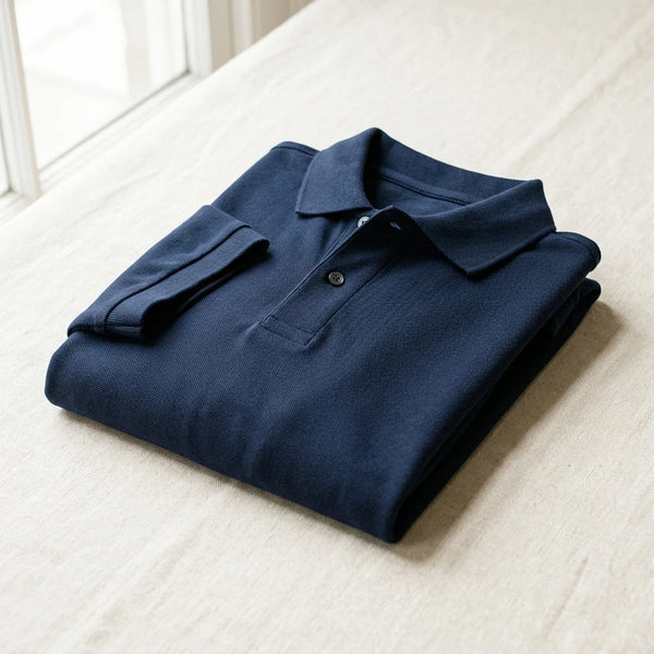 Folded navy piqué custom polo shirt sample with collar and placket — polo sampling by DenimByte