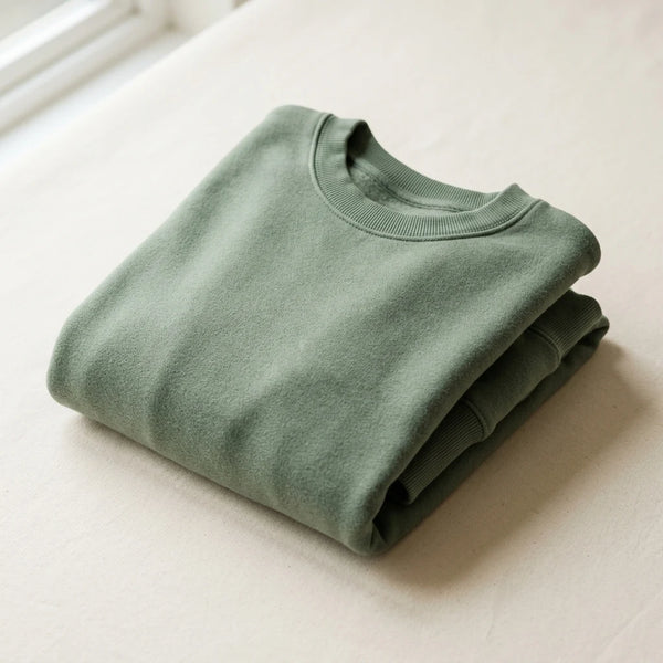 Folded sage green custom crewneck sweatshirt sample in brushed fleece — sweatshirt sampling by DenimByte