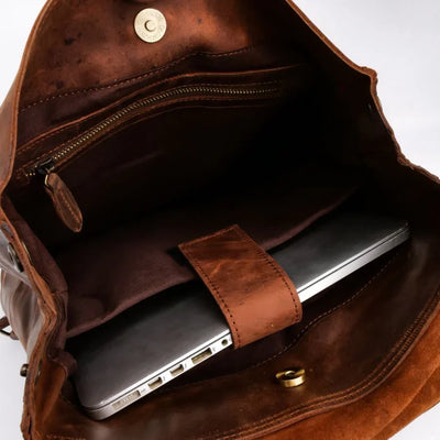 Vintage leather backpack interior layout showing laptop compartment zipper pocket and storage sections